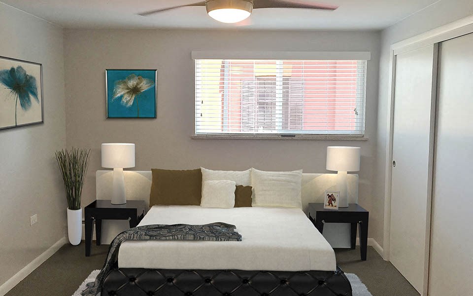 a bedroom with a bed and a ceiling fan