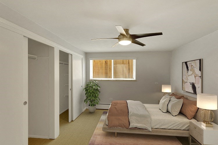 a bedroom with a bed and a ceiling fan