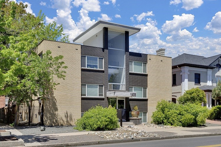 a brick apartment building with a street in front of it