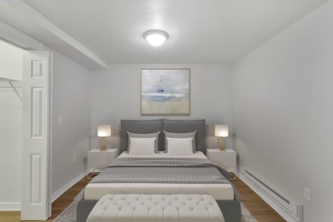 a bedroom with a bed and two nightstands and a painting