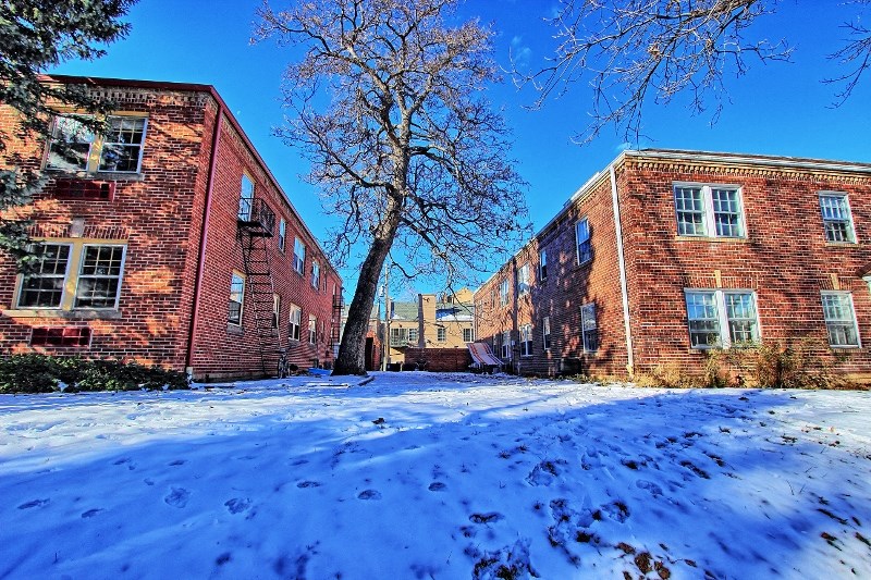 an old brick building in the snow