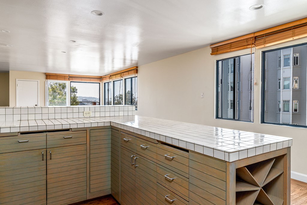 a kitchen with a counter top and a window