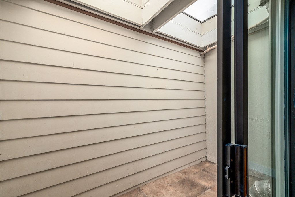 the side of a house with white siding and a window