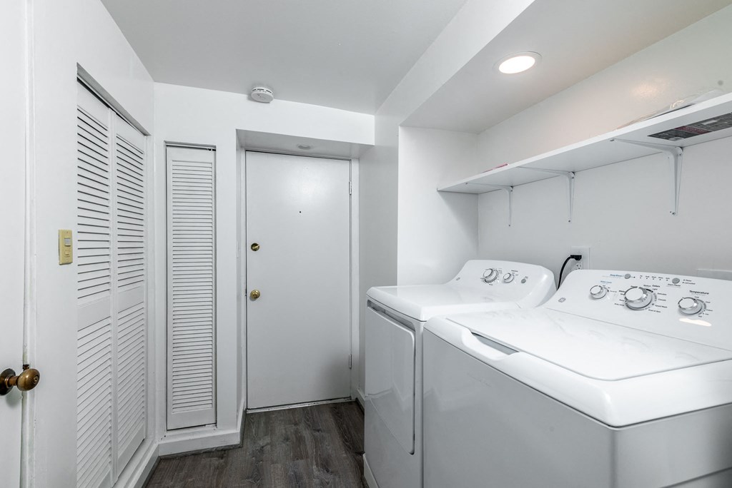 a laundry room with two washes and a dryer