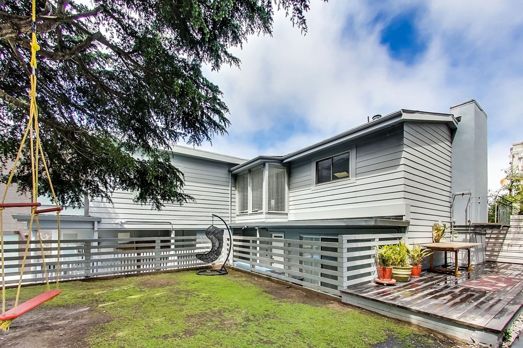 a white house with a yard and a white fence