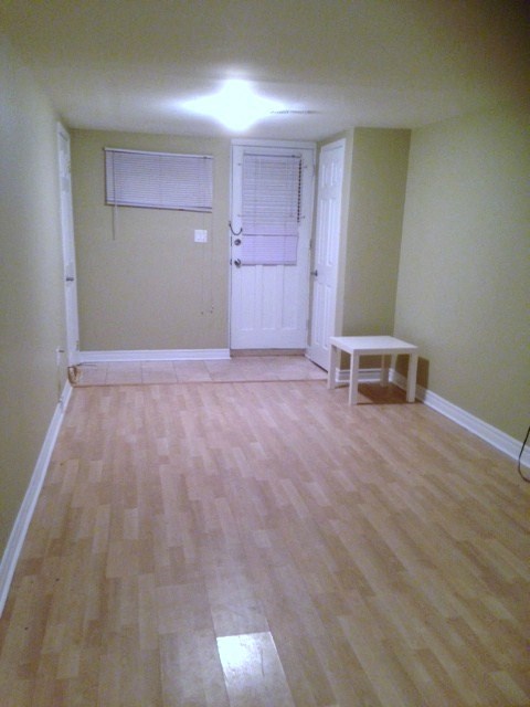 A room with a white door and a table.