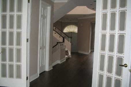 A hallway with a dog on the floor.