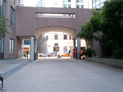 A large building with a covered walkway in front.