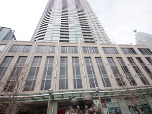 A tall building with a statue in front of it.