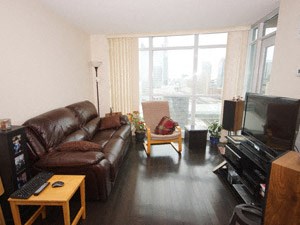 A living room with a brown leather couch and a wooden coffee table.