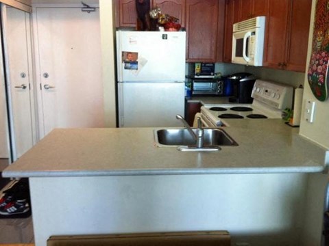 A kitchen with a white fridge and a white stove.