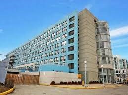 A large, modern building with a blue and beige facade.