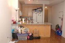A kitchen with wooden cabinets and a white fridge.