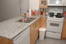 A kitchen with a white stove and a white dishwasher.