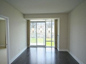 A room with a sliding glass door leading to a balcony.