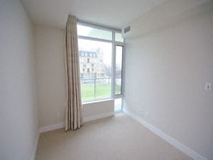 A room with a window and a curtain.