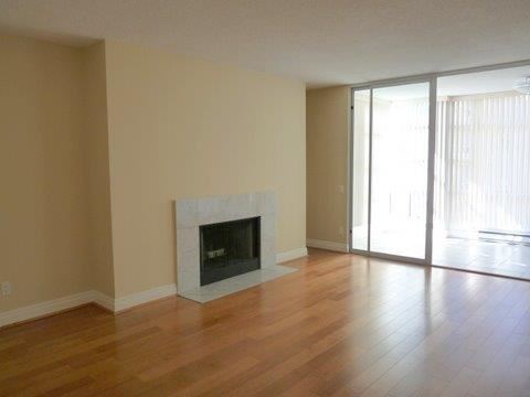 a living room with a fireplace and a wooden floor