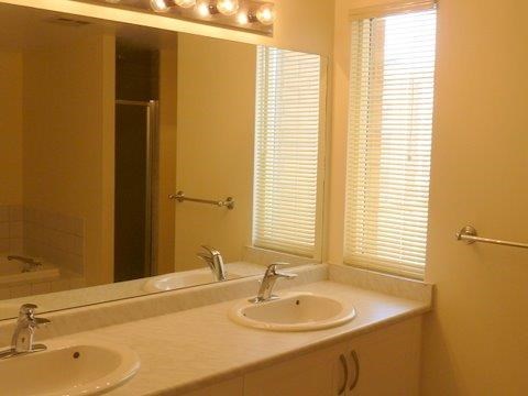 a bathroom with two sinks and a mirror