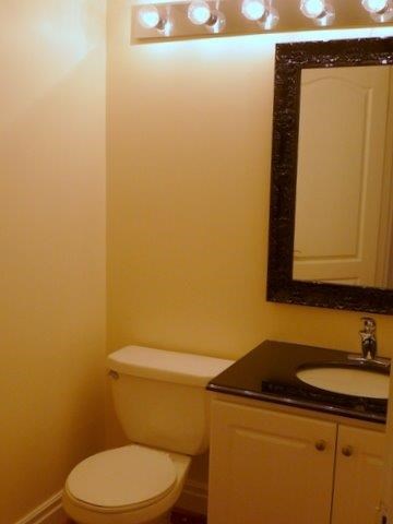 a bathroom with a toilet and a sink and a mirror