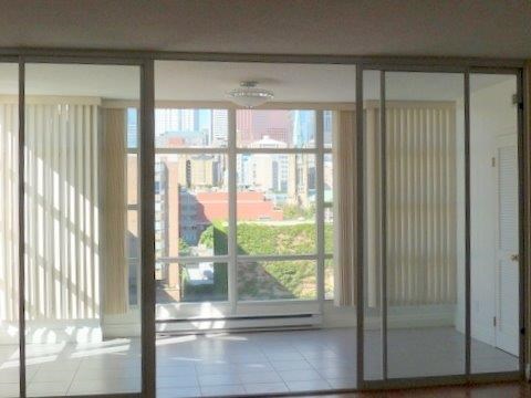 A room with sliding glass doors leading to a balcony.