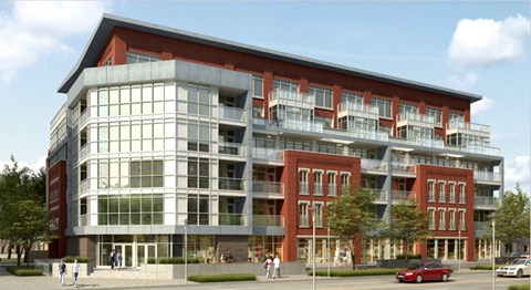 A modern building with a red brick facade and large windows.