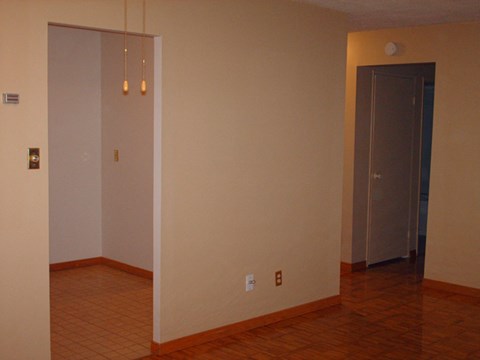 A room with a white door and a brown door.