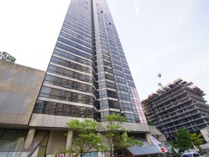 A tall building with a lot of windows is in the background.
