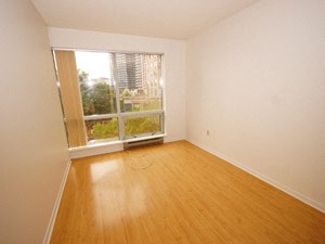Empty room with a window overlooking a city.