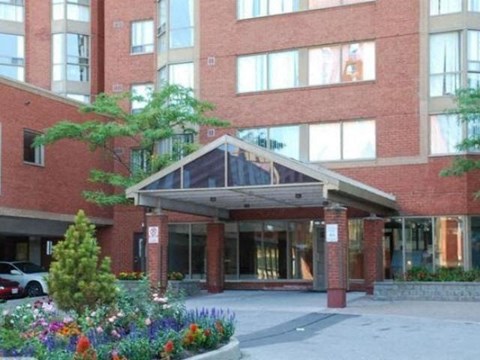 A building with a red brick facade and a glass entrance.