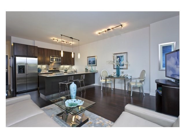 a living room and kitchen with a couch and a table
