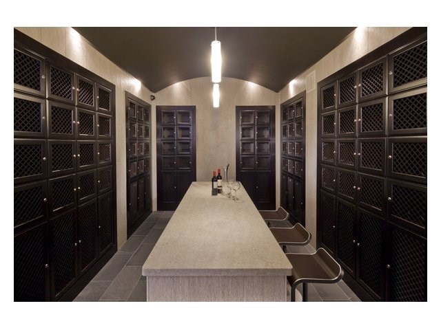 a tasting room with wine racks and a table and chairs