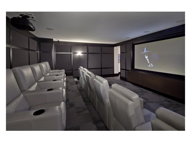 a movie theater with white chairs and a screen