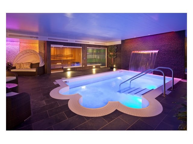 a spa with a pool and a waterfall