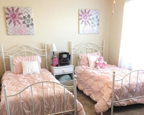 a bedroom with two beds and a window