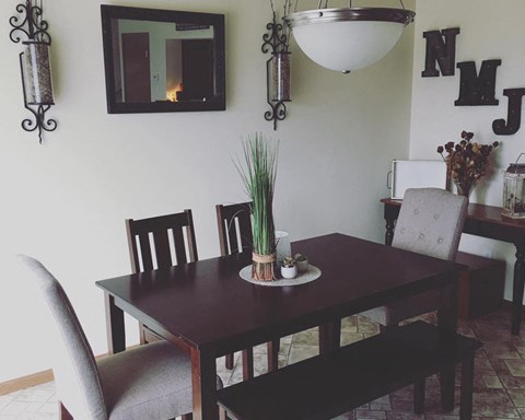 a dining room with a wooden table and chairs