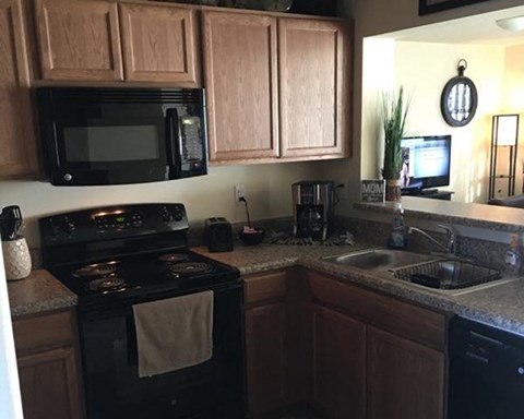 a kitchen with a stove microwave and a sink