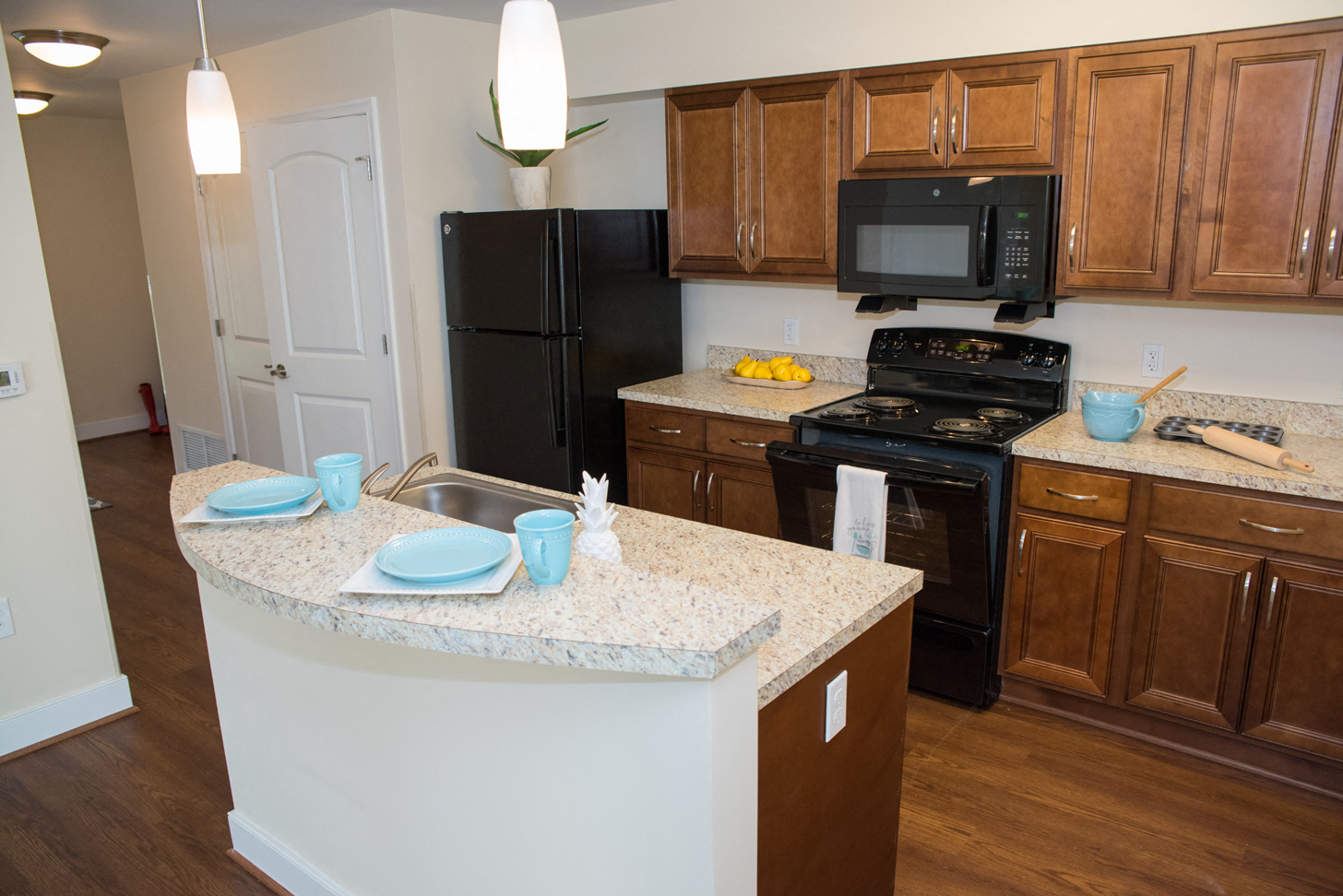 a kitchen with black appliances and granite counter tops