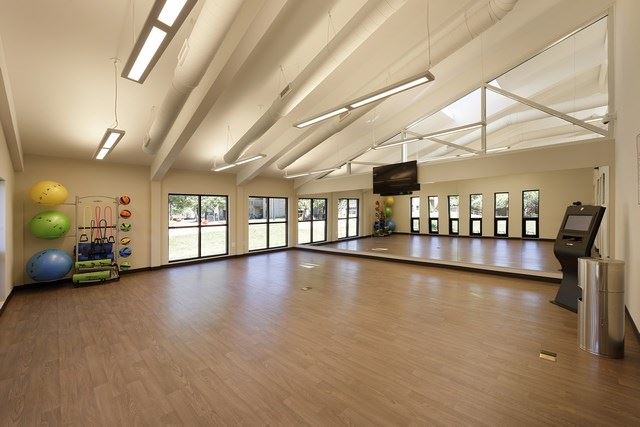 an empty room with a dance floor and a television