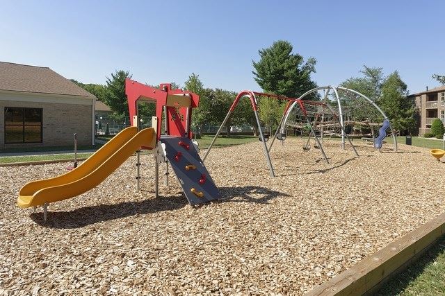 a playground with a swing set and a slide
