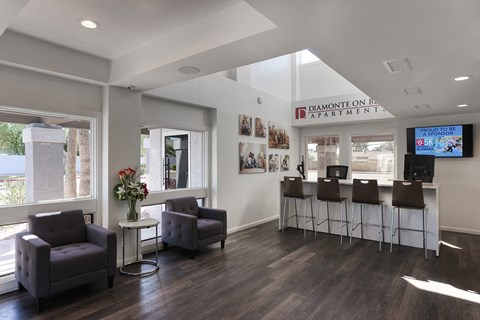 a room with a bar and chairs and a sign on the wall