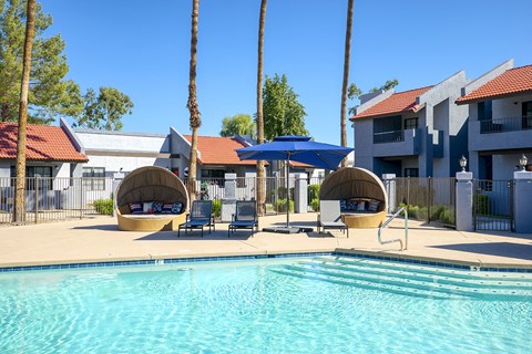our apartments have a resort style pool with lounge chairs and umbrellas