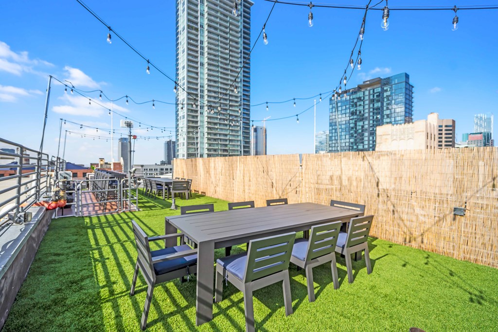 an outdoor patio with a table and chairs on a roof