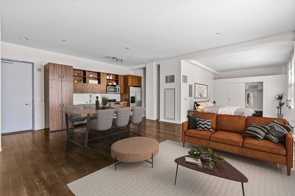 a living room with a couch and a table and a kitchen