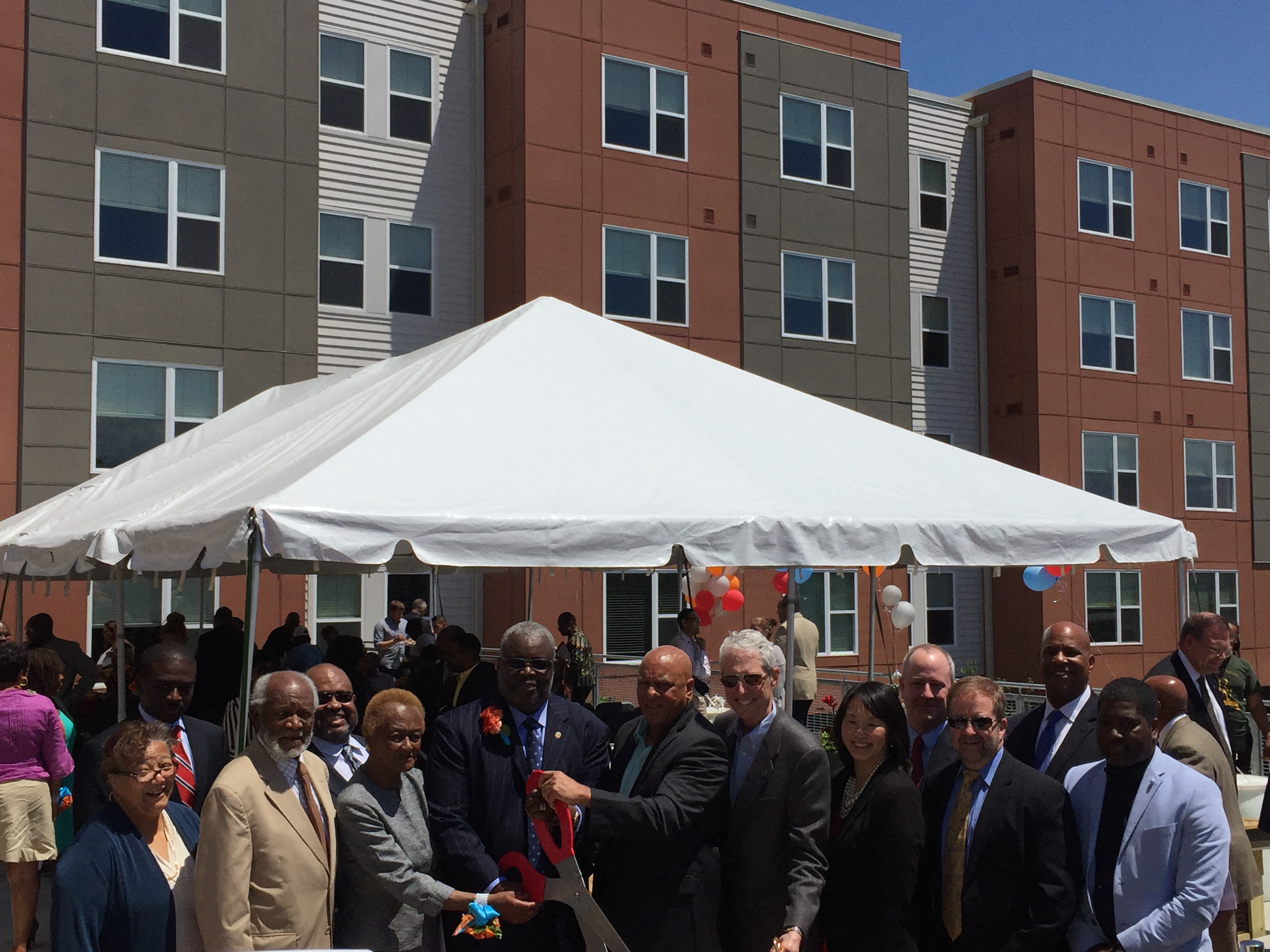 a group of people standing in front of a white tent