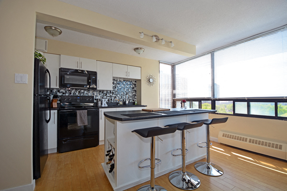 a kitchen with a island and a stove and a window