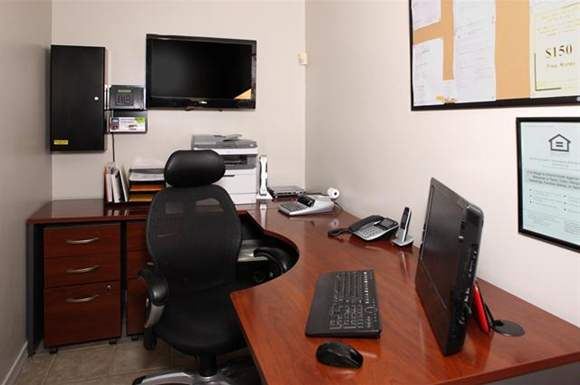 a desk with a monitor a keyboard and a mouse