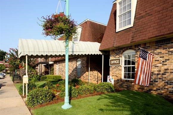 an flag on a pole in front of a brick building