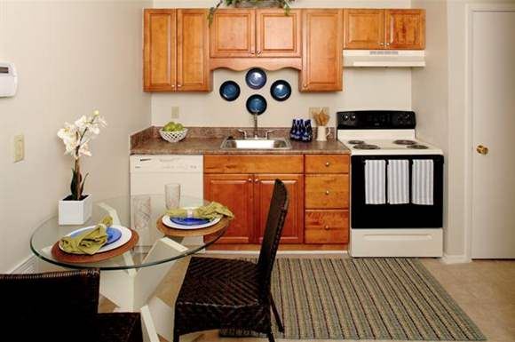 a kitchen with a stove a sink and a table