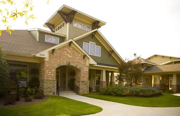 a house with a walkway and lawn in front of it