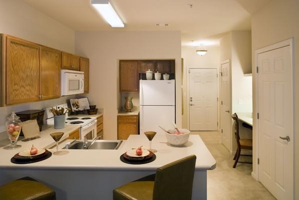 a kitchen with a counter and a sink and a refrigerator